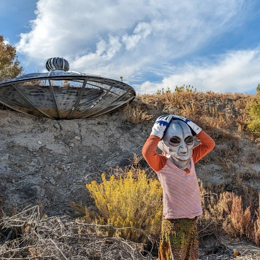 Alien wearing UFO Freezy Freakies at his crash site