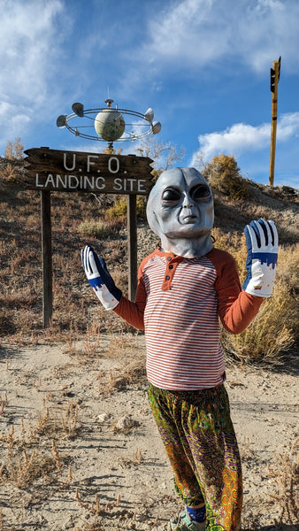 Alien wearing UFO Freezy Freakies at his landing site