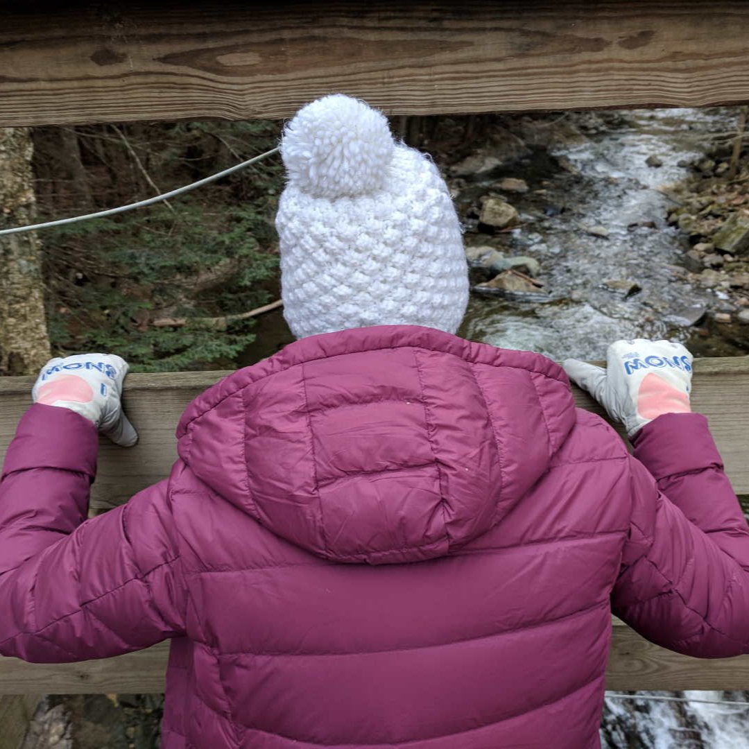 Lady in I Love Snow Freezy Freakies gloves saying goodbye to all the melted snow
