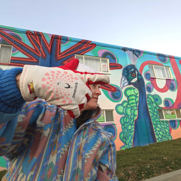 Freezy Freakies peacock gloves at a peacock mural